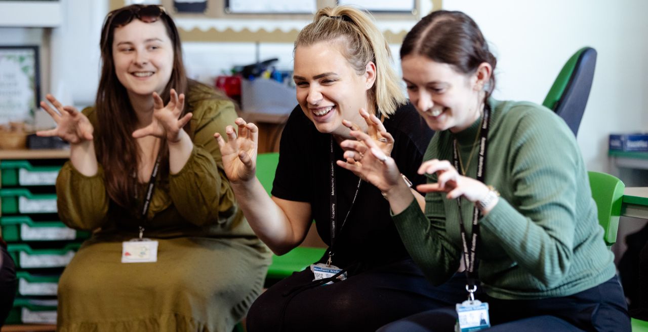 3 teachers taking part in a drama-based activity during a staff meeting as part of our Light Up School Learning project.