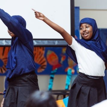 Light Up School Learning - two pupils taking part in a drama-based activity in the classroom.