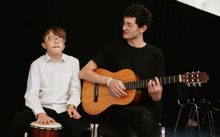 A facilitator and member of Louder Than Words taking part in our youth theatre sharing, 2022. Photo by Camilla Adams.