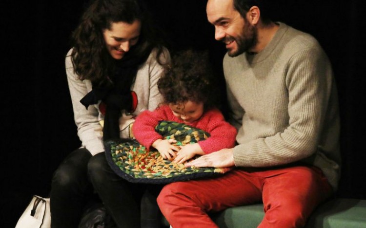 A young audience member plays with the texture of the Igloo mats.