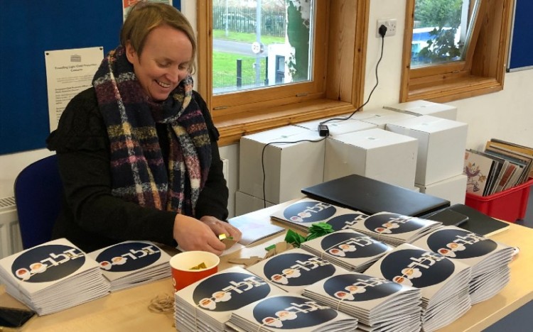 Louise adding some final touches to the storybooks before sending them out for distribution.