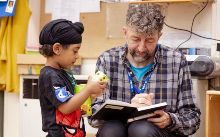 A child and facilitator taking part in a Light Up Language session. Photo by Camilla Adams.