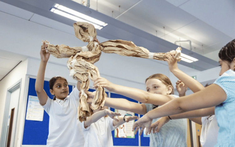 Participants taking a paper puppet on a journey. Photo by Camilla Adams.